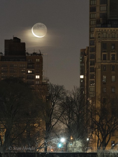 Jan. 7, 2016: A beautiful crescent moon rises between east side buildings.